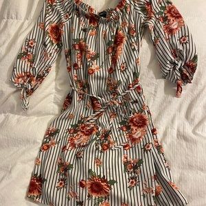 White blouse with black lines and pink flowers